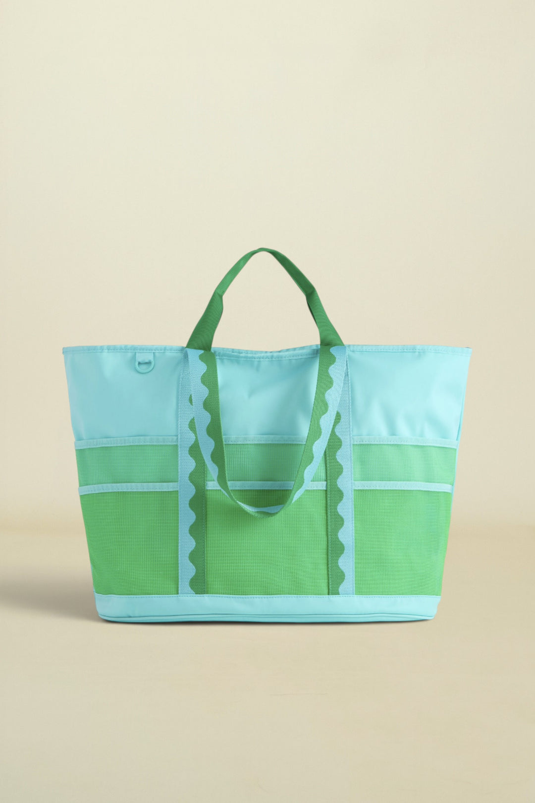 Green and blue tote bag on a beige background