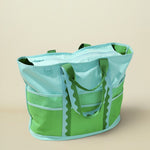 Green and light blue tote bag on a beige background