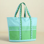 Green and light blue tote bag on a beige background