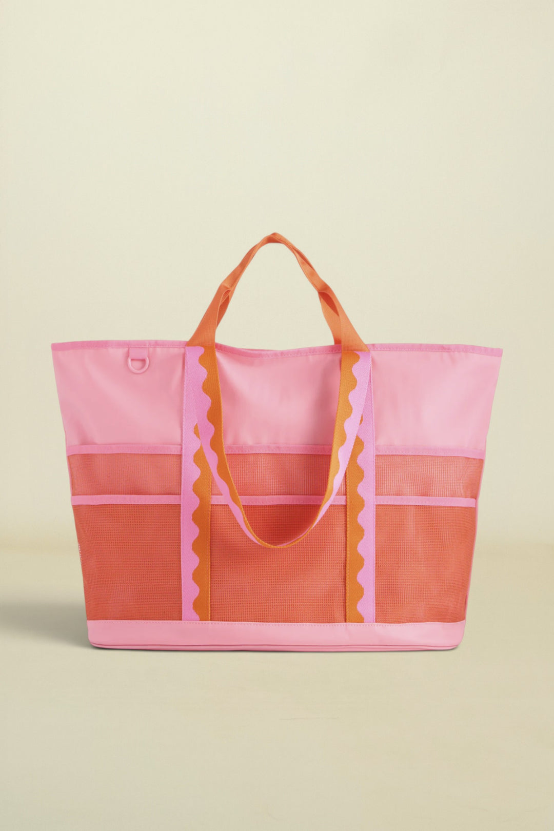 Pink and orange tote bag with ruffled details on a white background