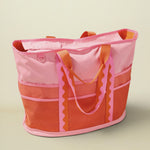 Pink and orange tote bag on a beige background