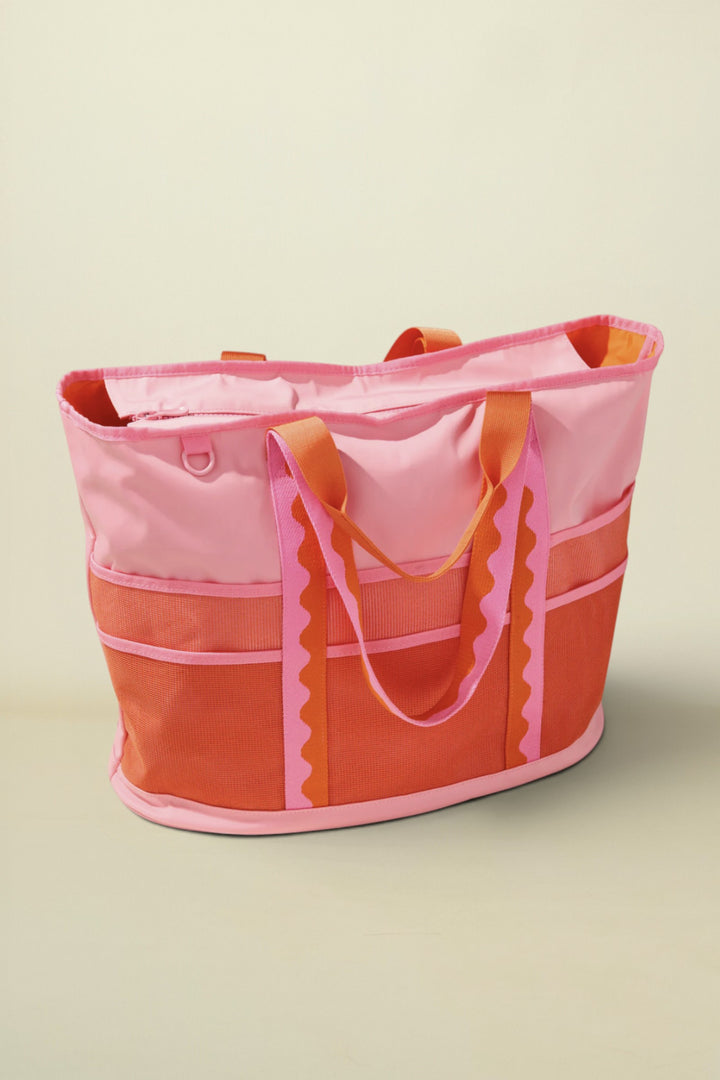 Pink and orange tote bag on a beige background