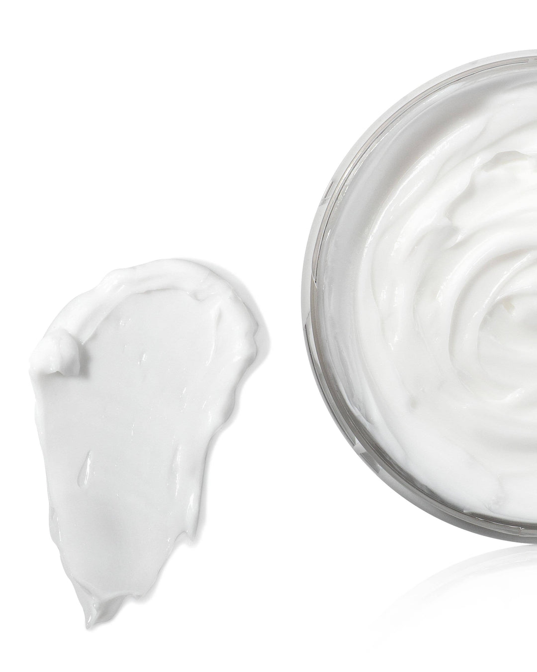 Jar of white cream with a swirl on a white background