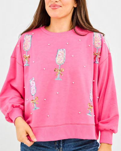 Woman wearing a pink sweatshirt with decorative elements on a white background