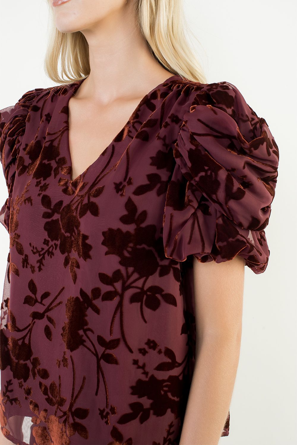 Maroon floral top with ruffled sleeves on a white background