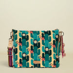 Point of Origin CONSUELA Desi Downtonw crossbody bag with a vibrant cactus print, colorful woven strap, and decorative tassel charm.