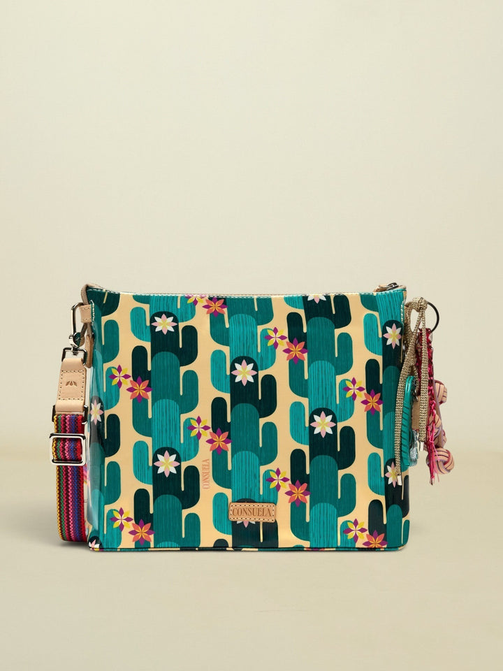 Point of Origin CONSUELA Desi Downtonw crossbody bag with a vibrant cactus print, colorful woven strap, and decorative tassel charm.