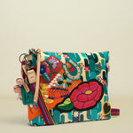 Point of Origin CONSUELA Desi Downtown crossbody bag with cactus print, colorful floral embroidery, horseshoe patch, and tassel.