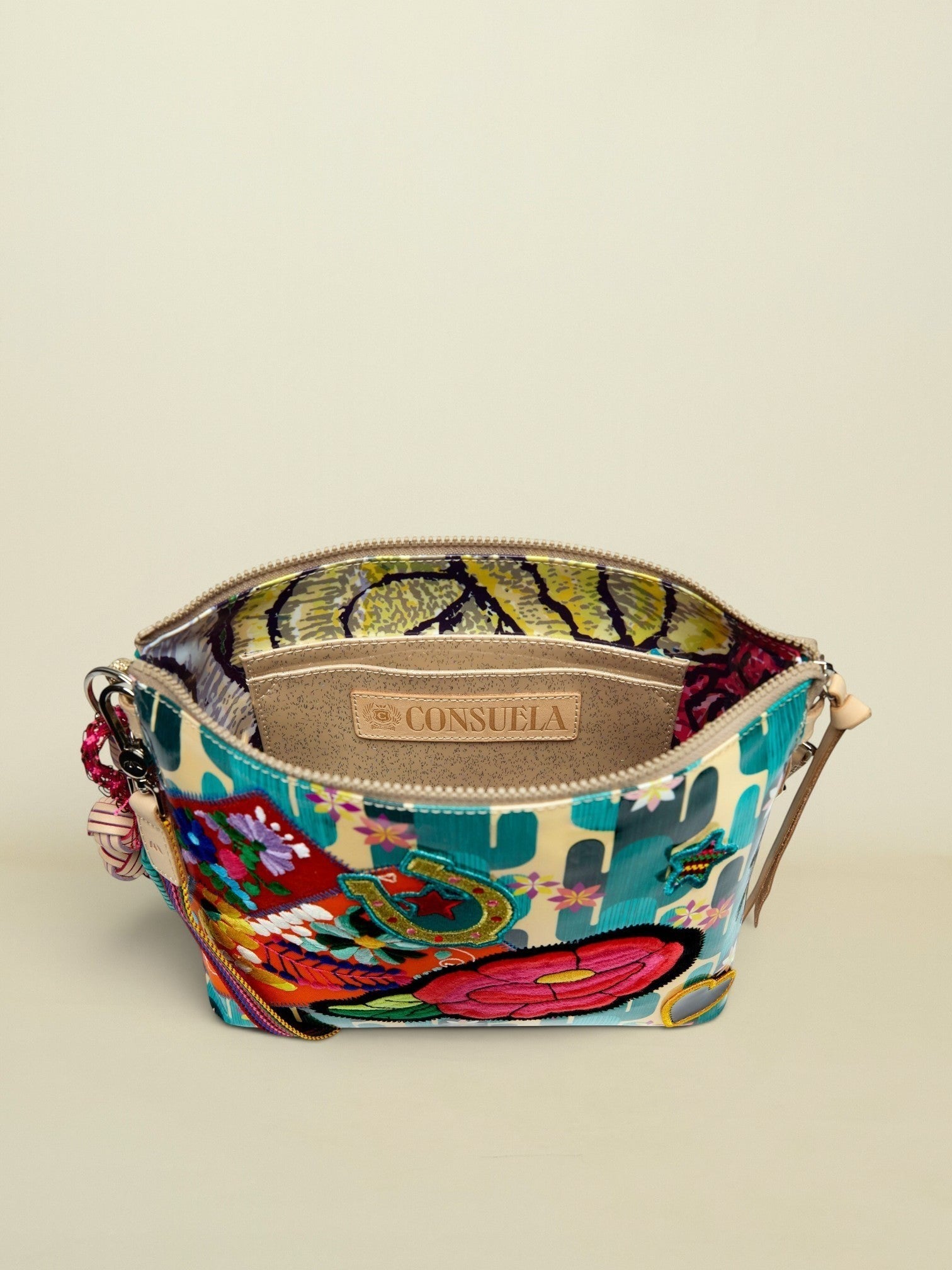 Point of Origin CONSUELA Desi Downtown crossbody bag with vibrant cactus print, embroidered patches, and interior slip pocket.