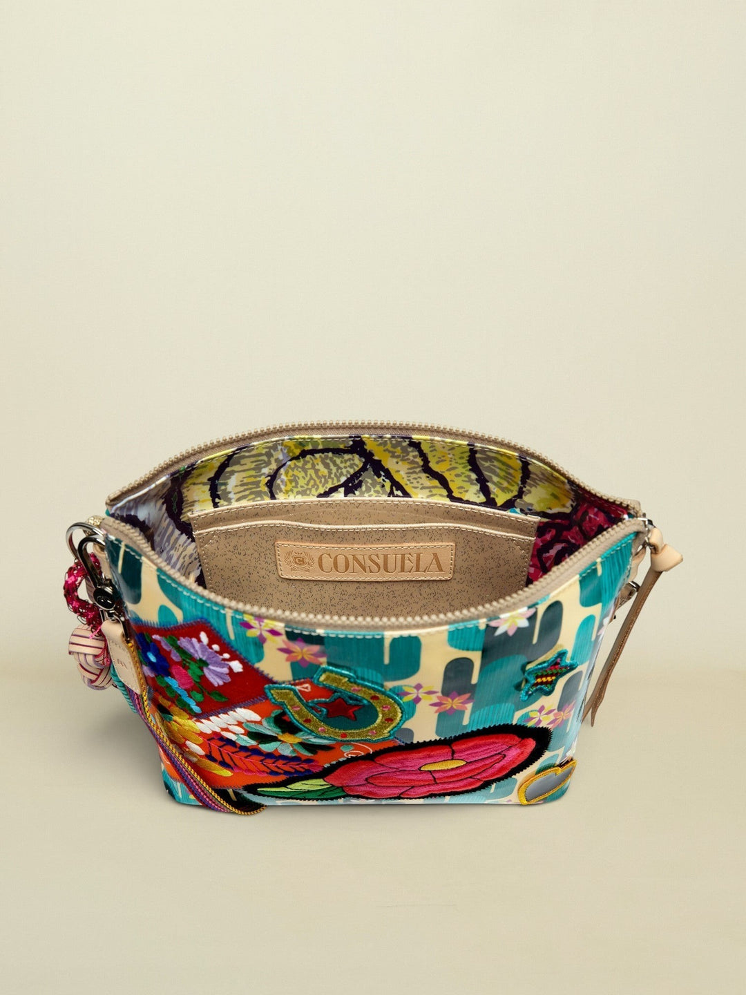 Point of Origin CONSUELA Desi Downtown crossbody bag with vibrant cactus print, embroidered patches, and interior slip pocket.