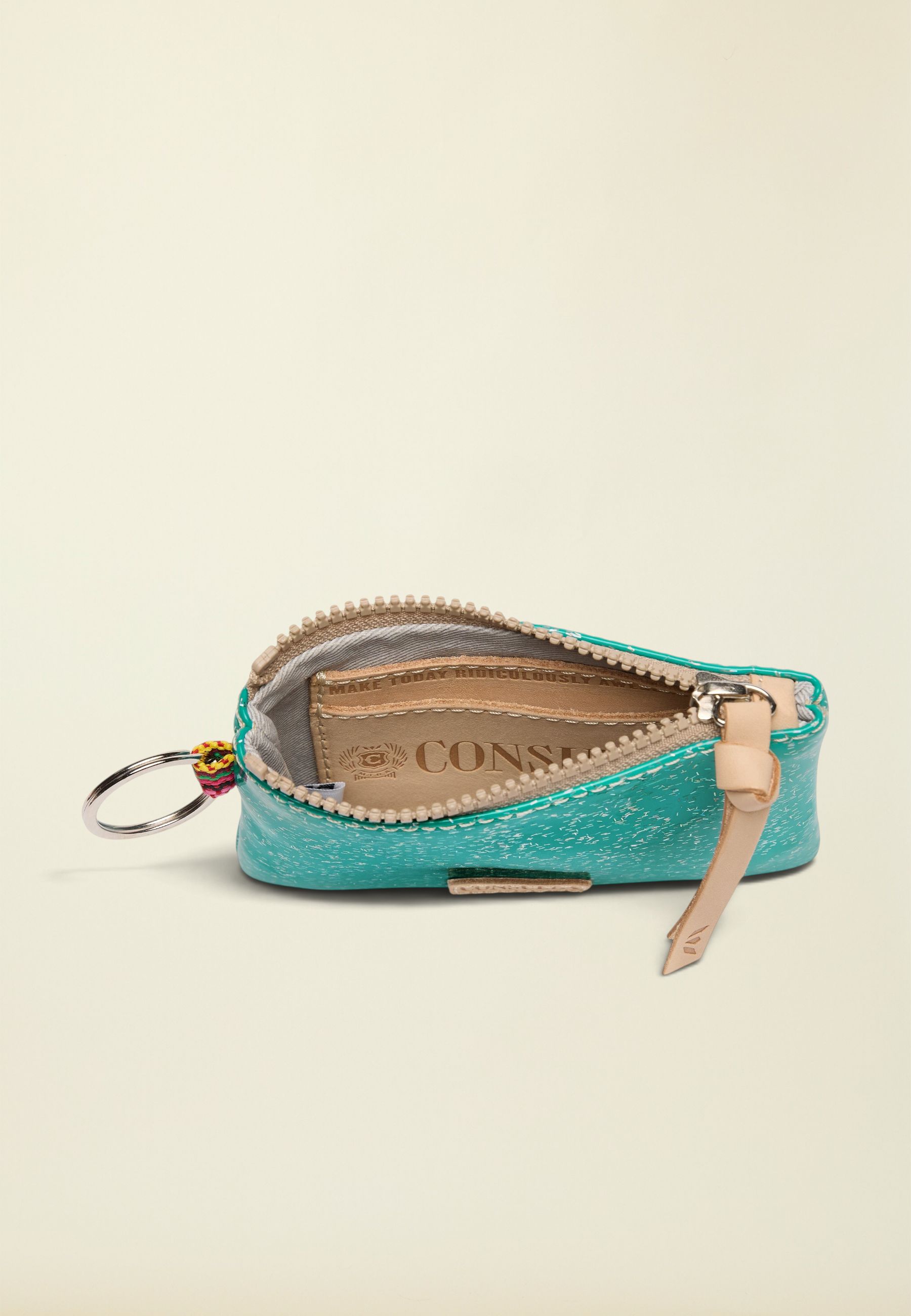 Point of Origin Consuela Shay glitter pouch in teal with a natural leather zipper pull and interior card slot.