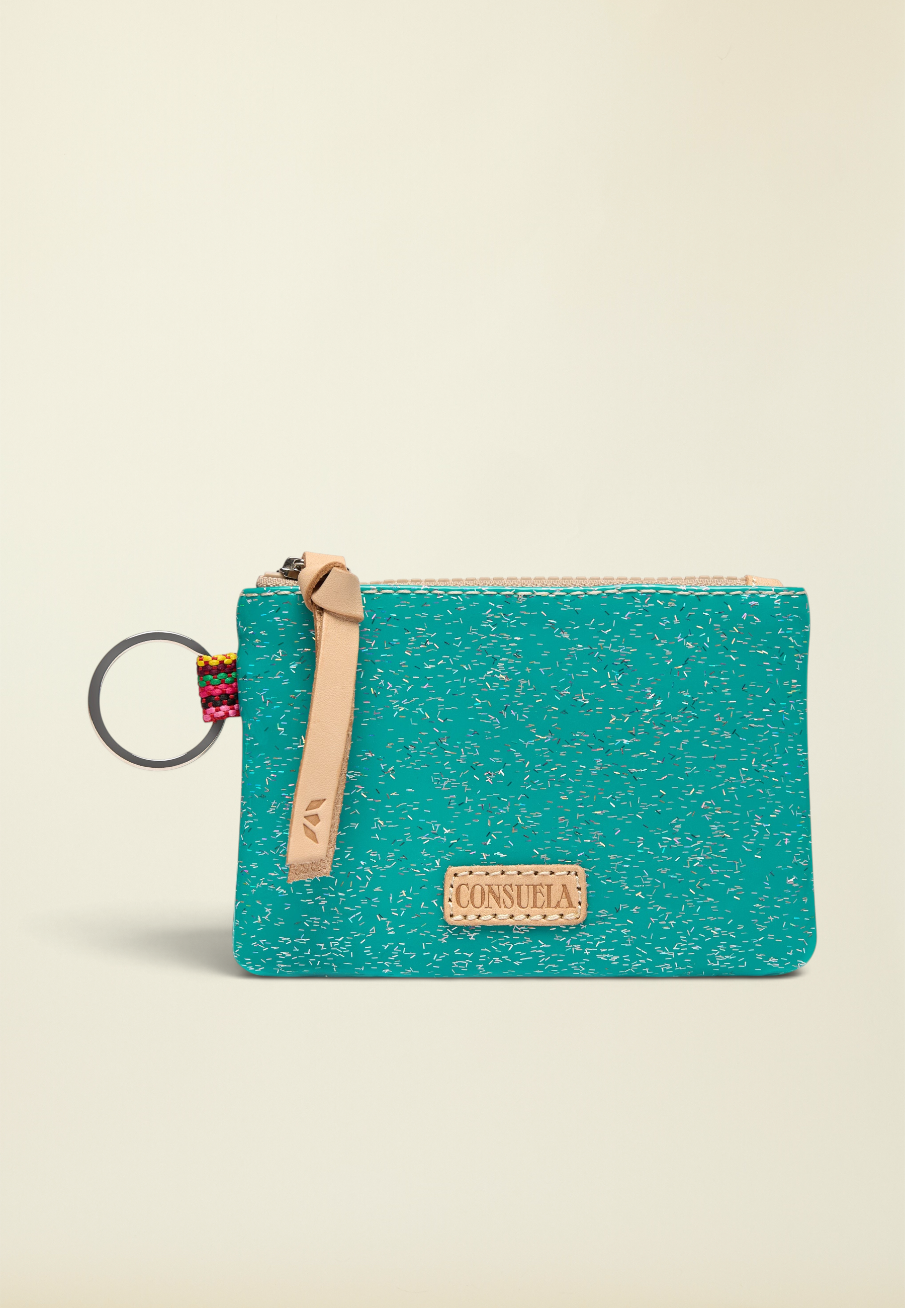Point of Origin Consuela Shay glitter pouch in teal with natural leather pull, logo patch, and attached metal keyring.