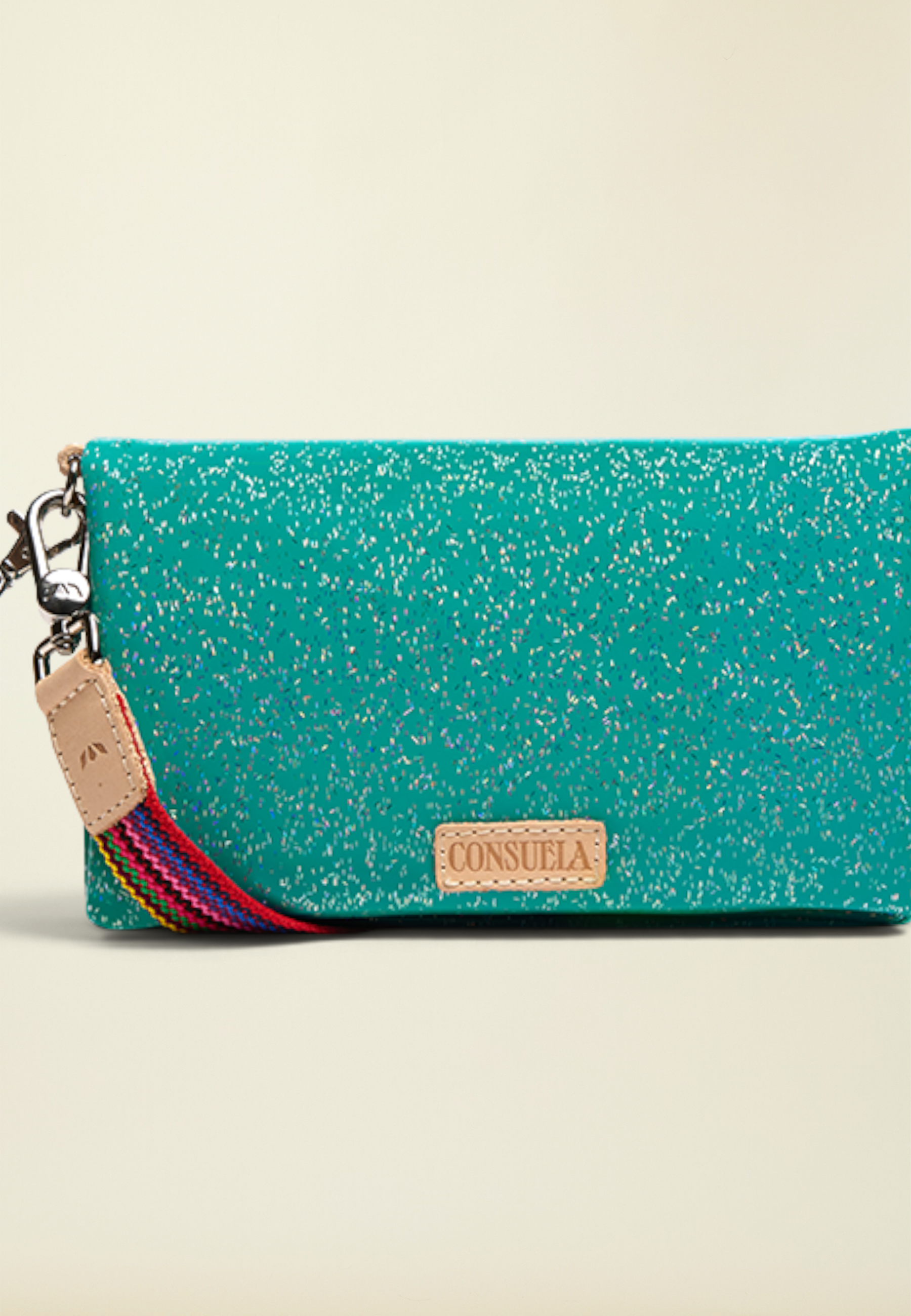 Point of Origin Consuela Shay Uptown Crossbody in teal with silver flecks, natural leather trim, and wristlet strap.