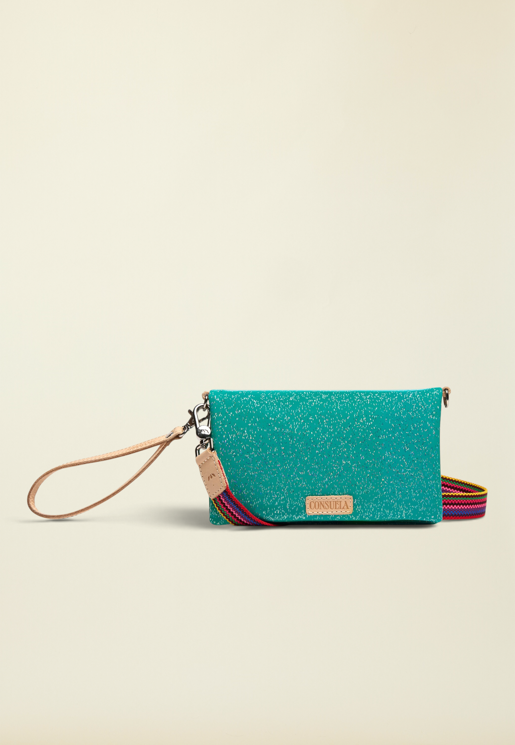 Point of Origin Consuela Shay Uptown Crossbody in teal with natural leather trim and a colorful woven strap.