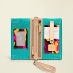 Point of Origin Consuela Shay Uptown Crossbody in teal with colorful camo accents, leather trim, and interior card slots.