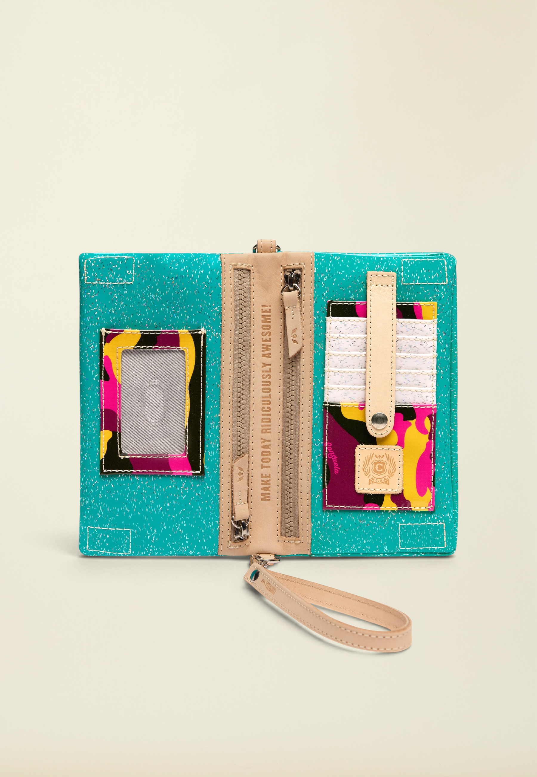 Point of Origin Consuela Shay Uptown Crossbody in teal with colorful camo accents, leather trim, and interior card slots.
