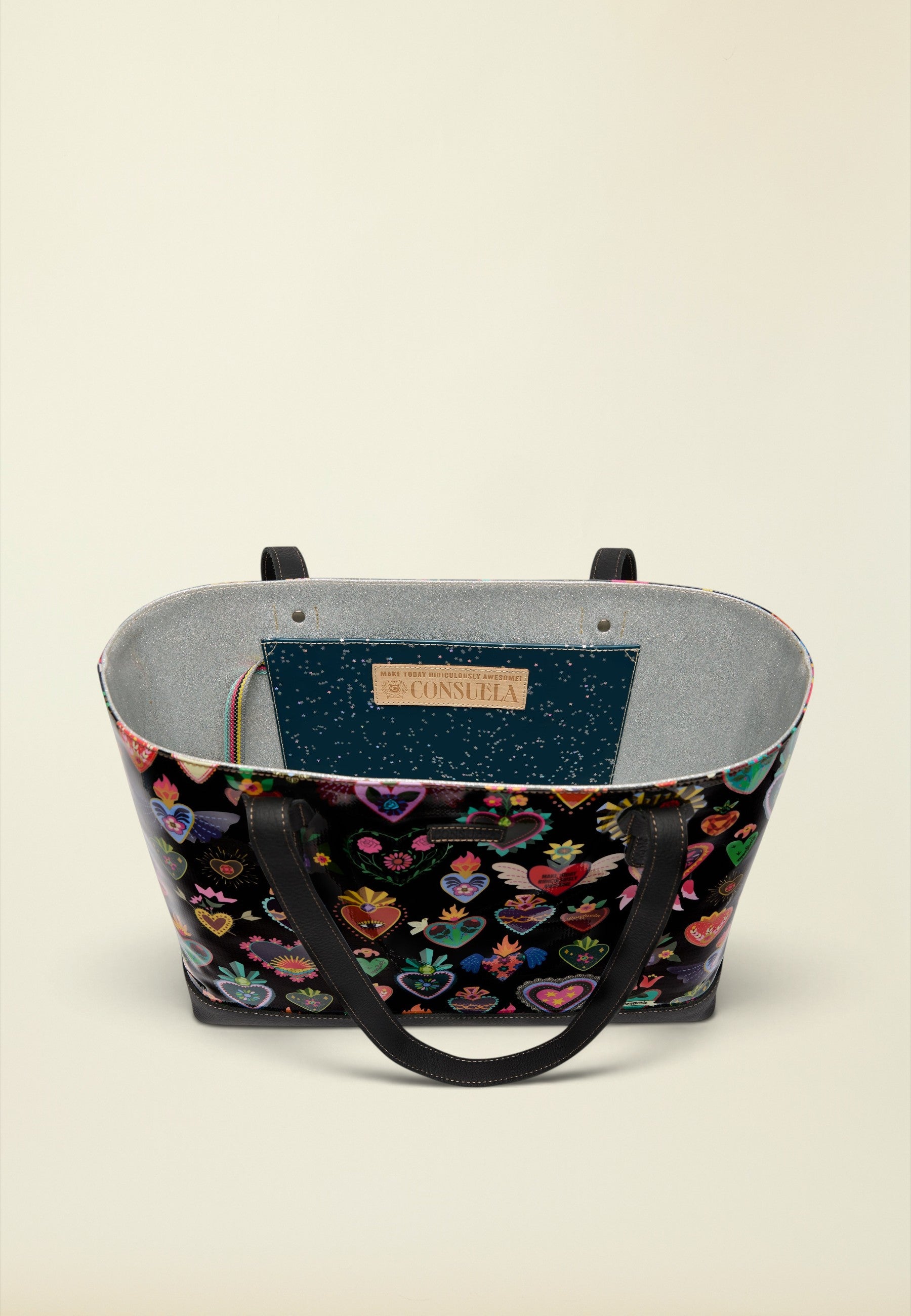 Point of Origin Consuela Vida Big Breezy tote bag with black heart-patterned exterior and grey glitter interior.