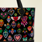 Point of Origin Consuela Vida Big Breezy tote bag featuring a black exterior with colorful heart patterns and leather straps