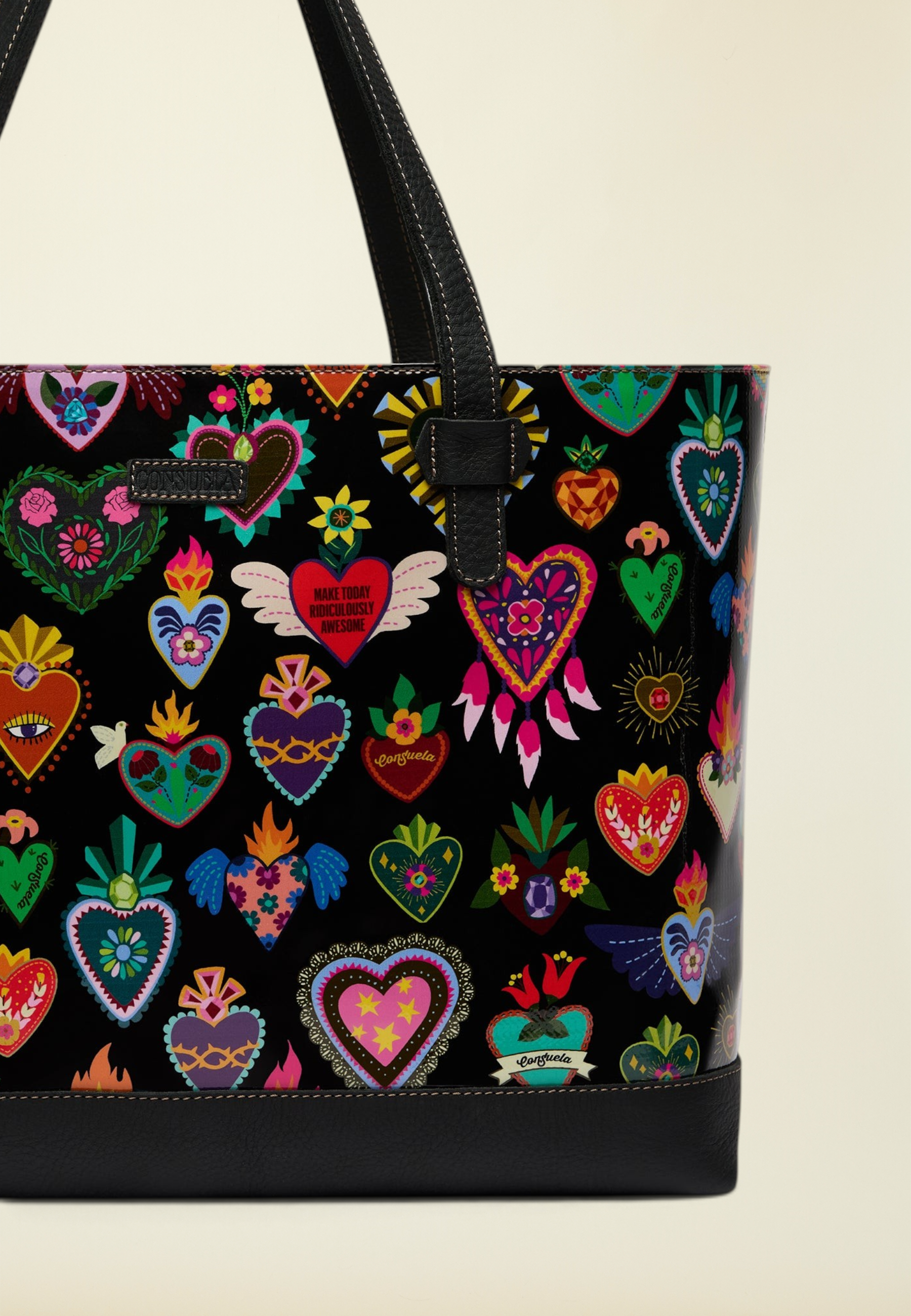 Point of Origin Consuela Vida Big Breezy tote bag featuring a black exterior with colorful heart patterns and leather straps