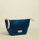 Blue cosmetic bag with beige zipper on a white background