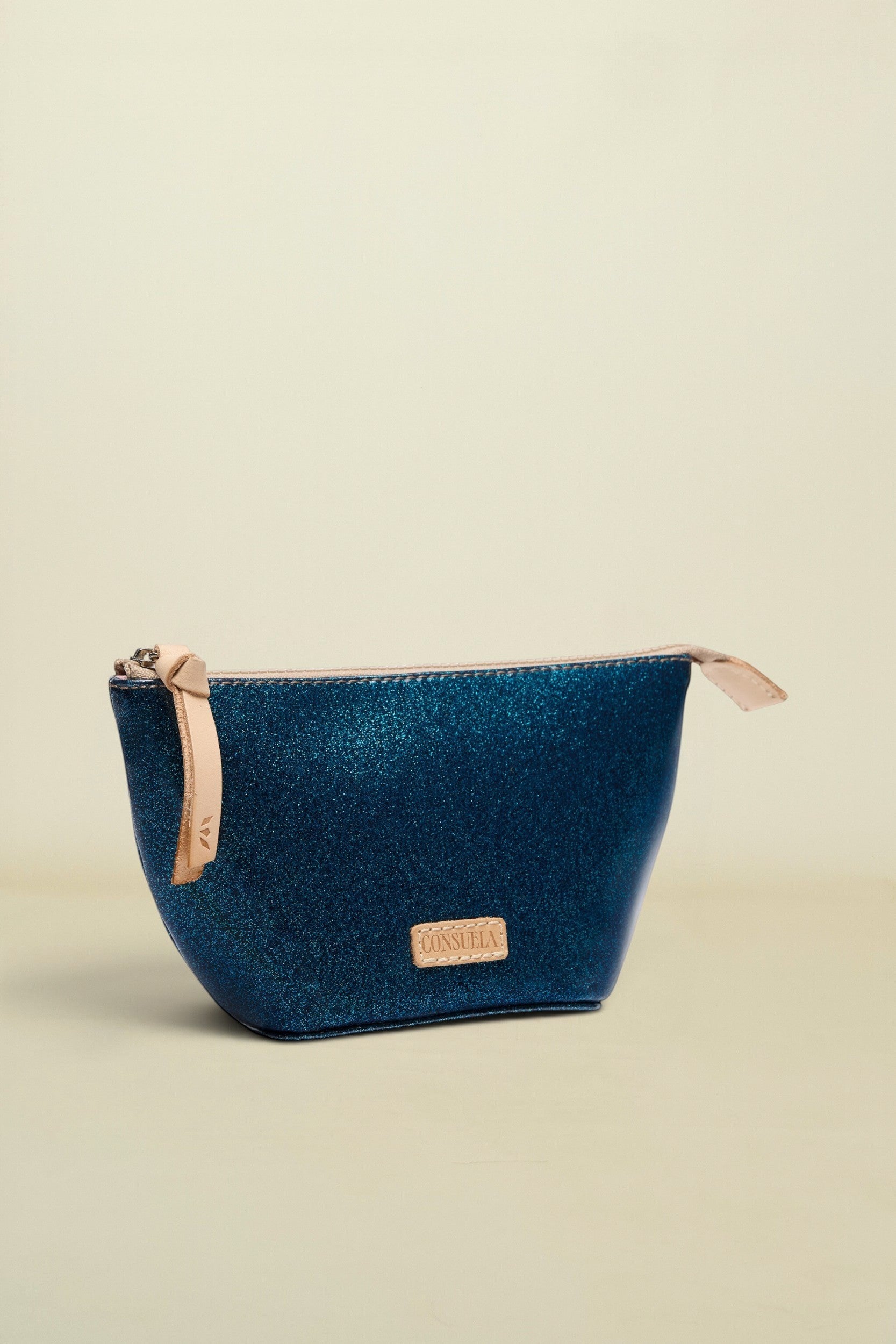 Blue cosmetic bag with beige zipper on a white background
