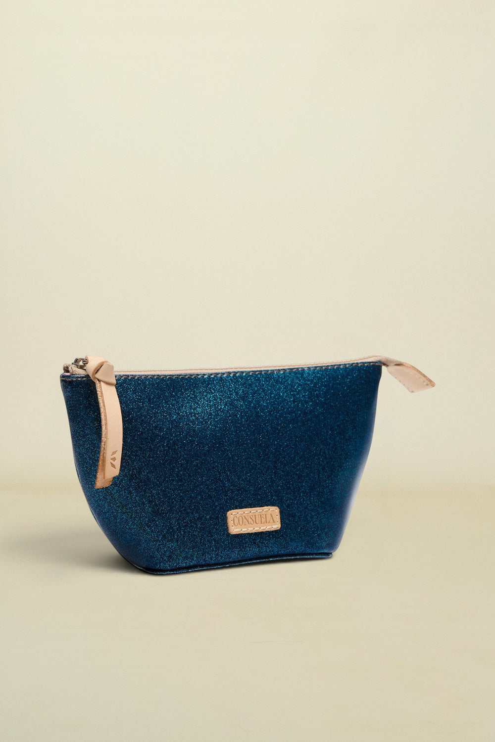 Blue cosmetic bag with beige zipper on a white background