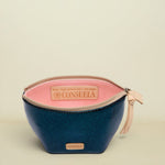 Two-toned cosmetic bag with pink top and navy bottom, featuring Consuela branding.
