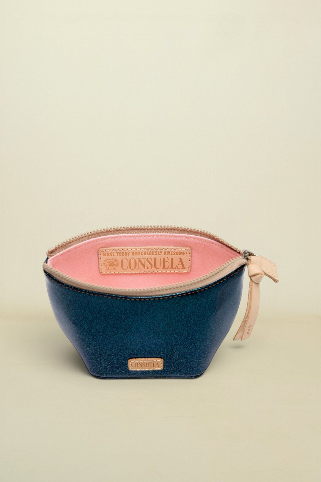Two-toned cosmetic bag with pink top and navy bottom, featuring Consuela branding.
