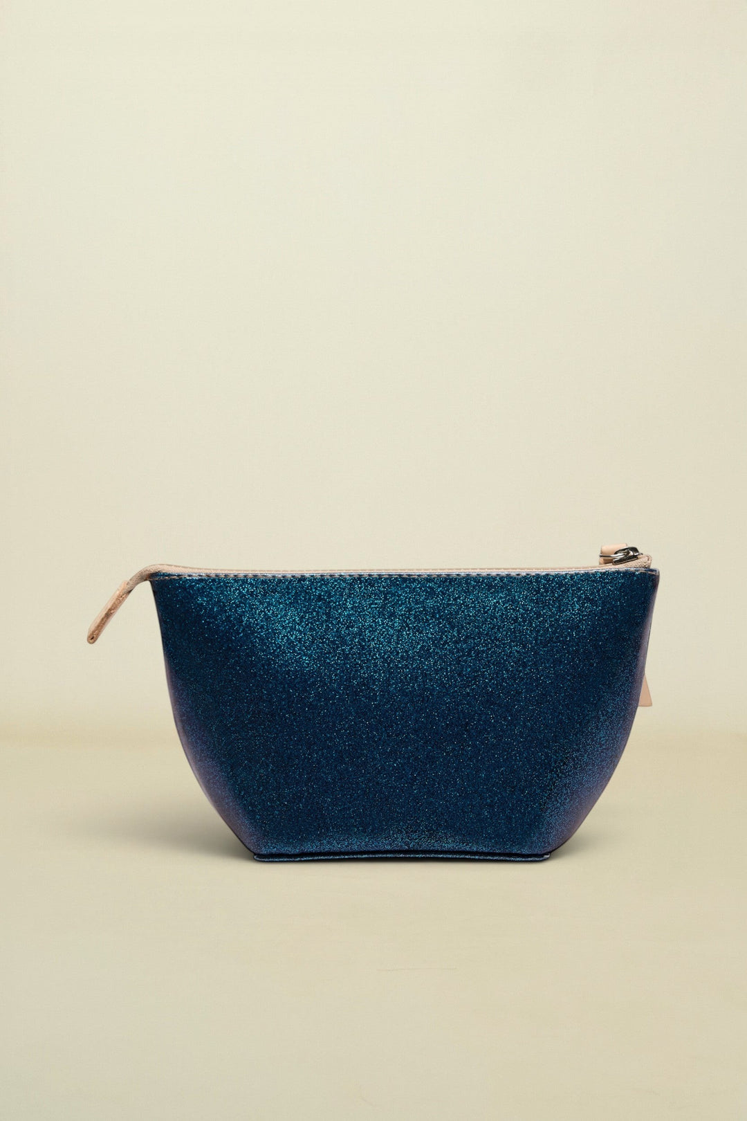 Blue denim pouch with gold zipper on a white background