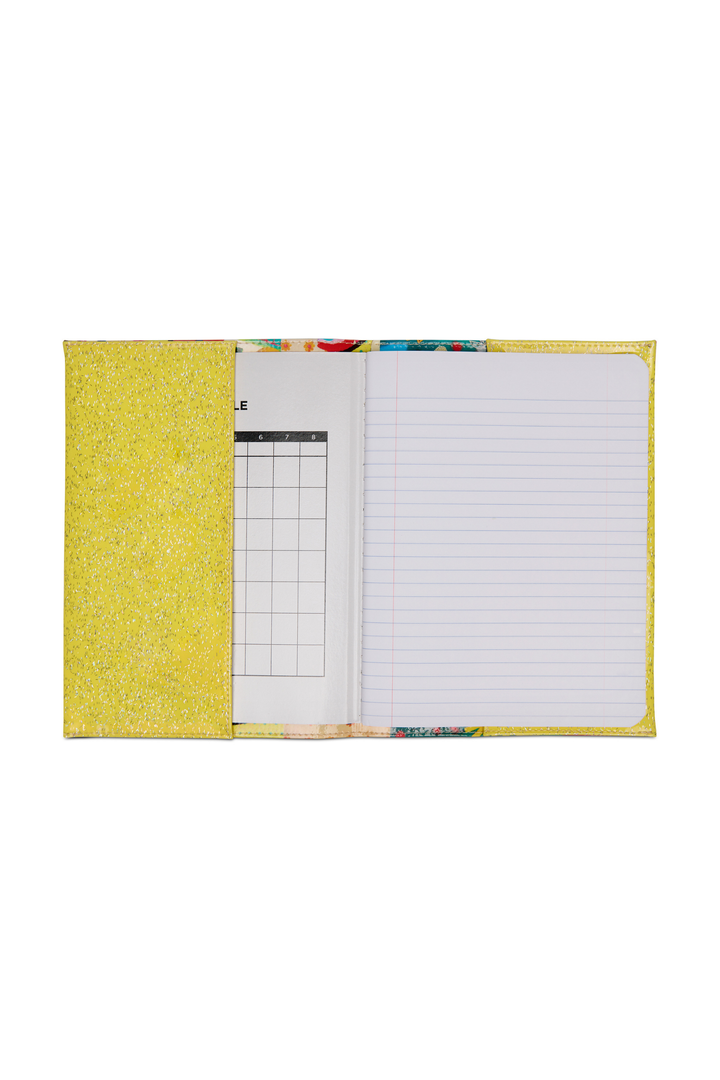 Notebook with colorful cover and grid and lined pages on a white background