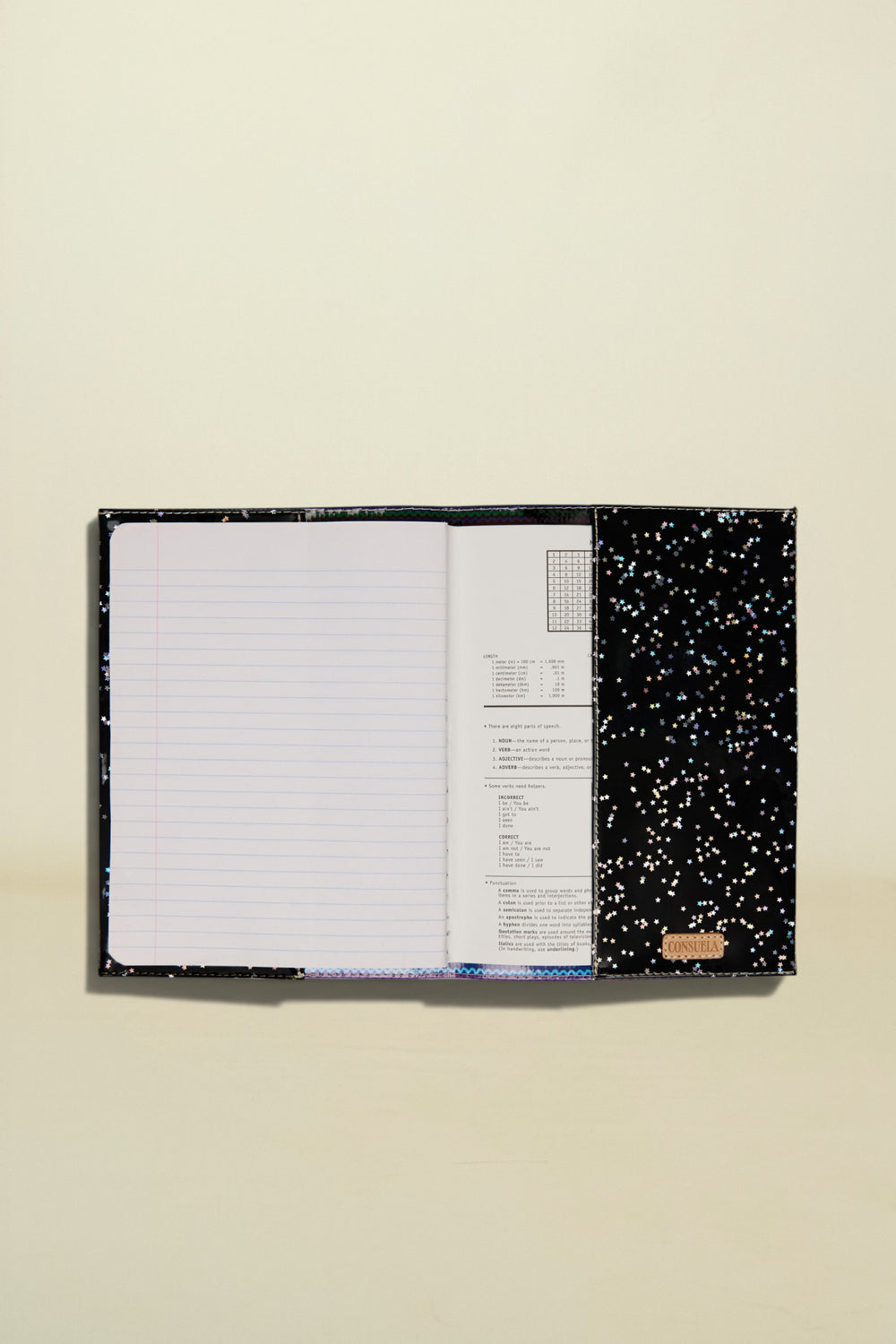 Open notebook with black splatter design on a white background