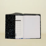Notebook with starry night design on cover and grid and lined pages inside