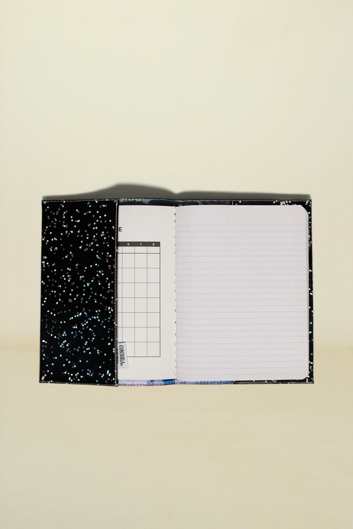 Notebook with starry night design on cover and grid and lined pages inside