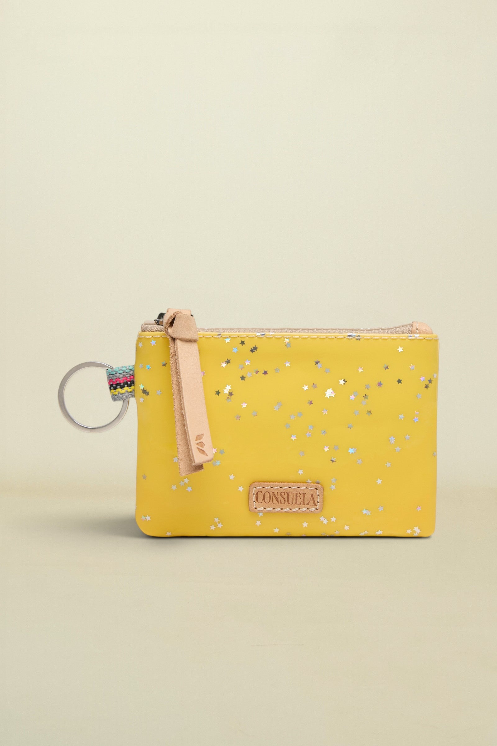 Yellow pouch with floral pattern and keychain on a white background