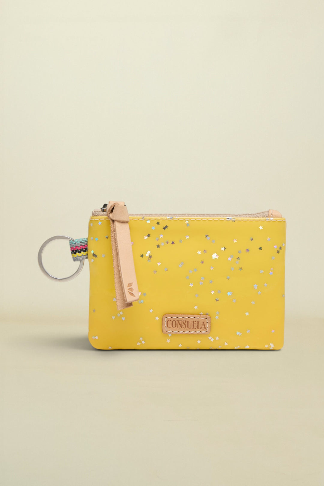 Yellow pouch with floral pattern and keychain on a white background