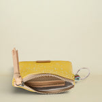 Yellow coin purse with a key ring on a white background