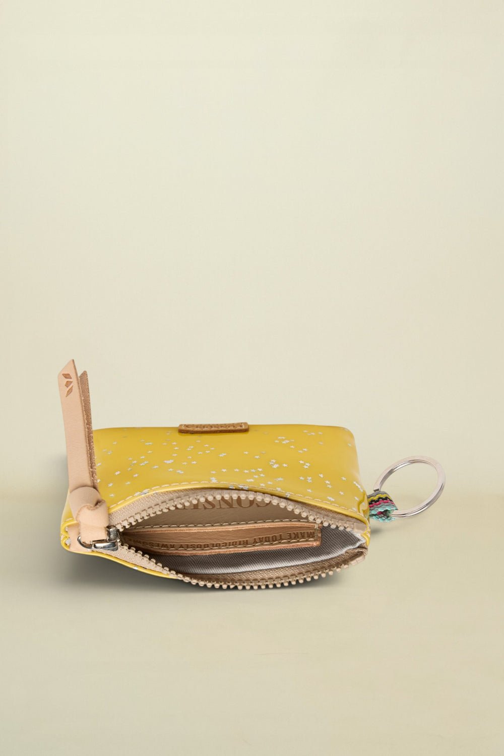 Yellow coin purse with a key ring on a white background