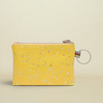 Yellow glittery pouch with a keyring on a white background