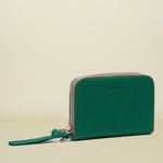 Green wallet with a strap on a white background