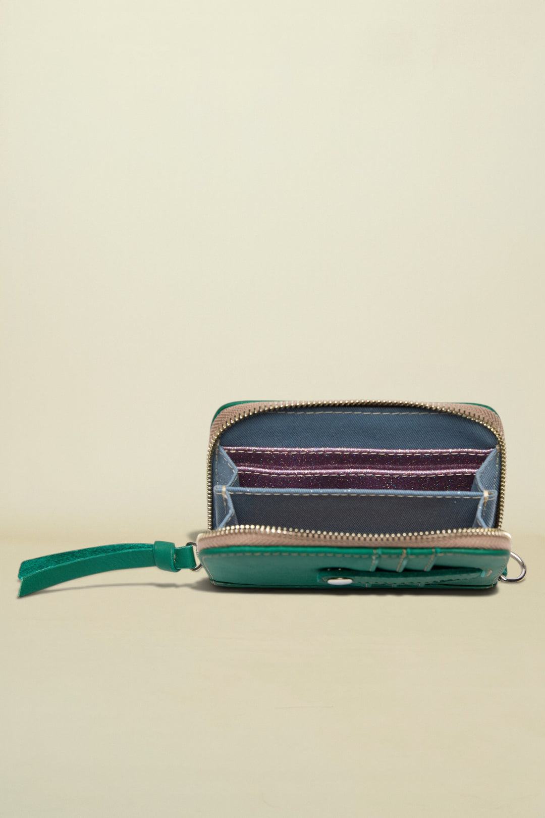 Small zippered pouch with a colorful interior on a white background