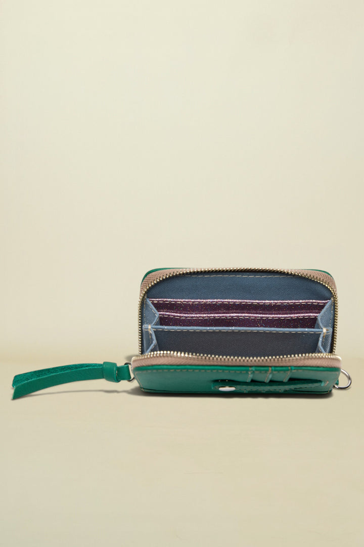 Small zippered pouch with a colorful interior on a white background