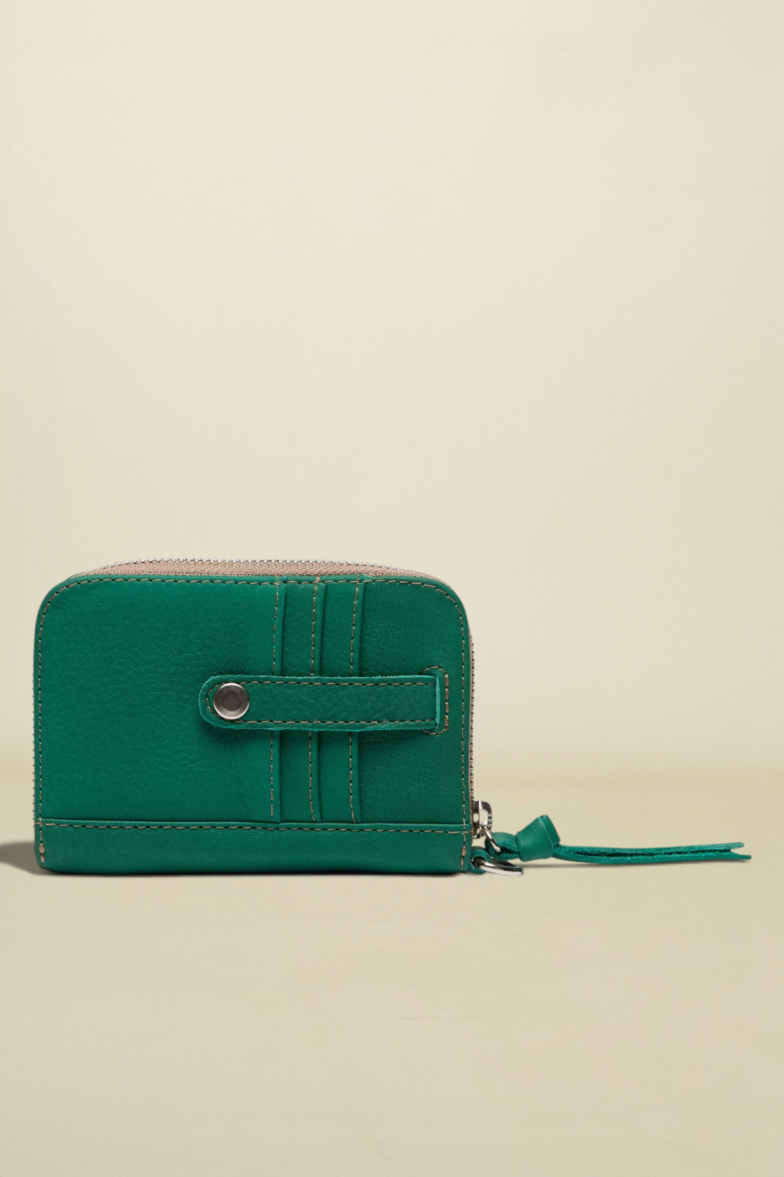 Green wallet with a zipper on a white background
