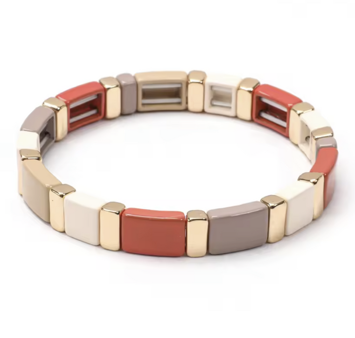 Multicolored bracelet with gold accents on a white background