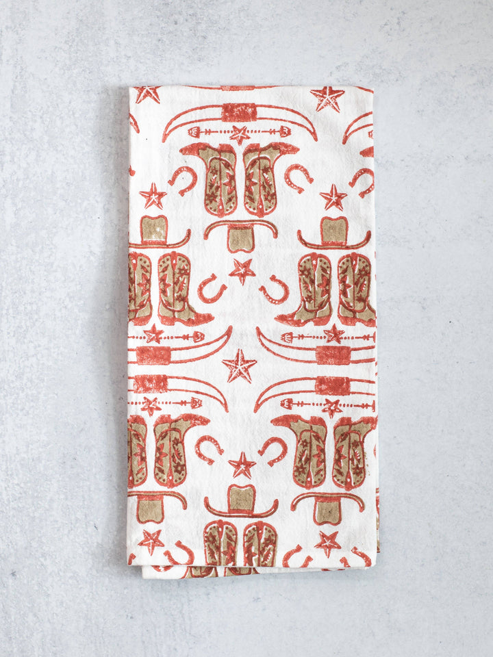 Folded fabric with cowboy boot pattern on a gray background