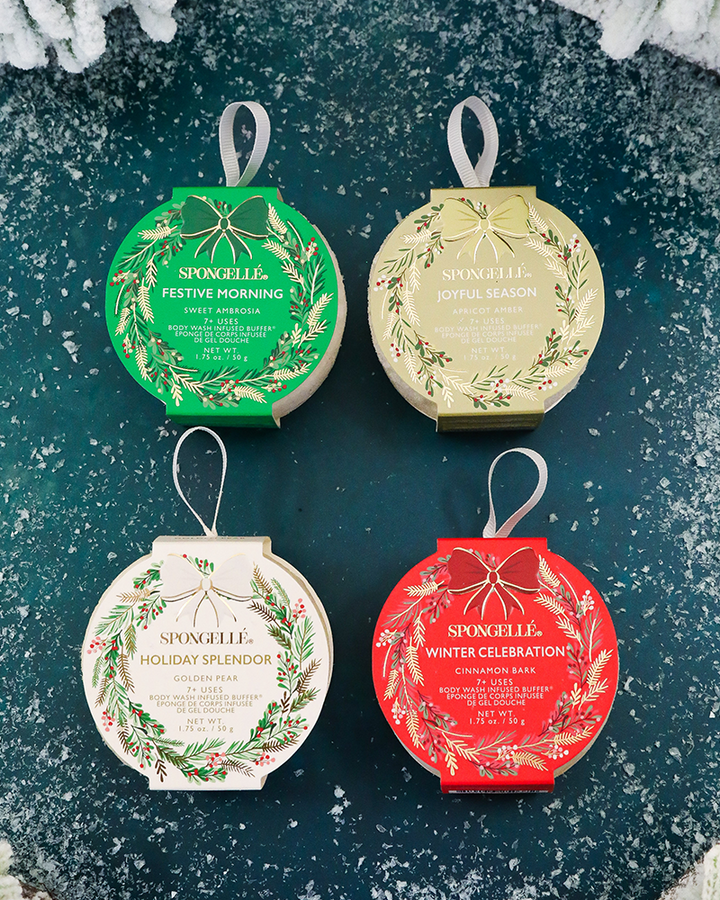 Four decorative ornaments with festive designs on a textured green background.
