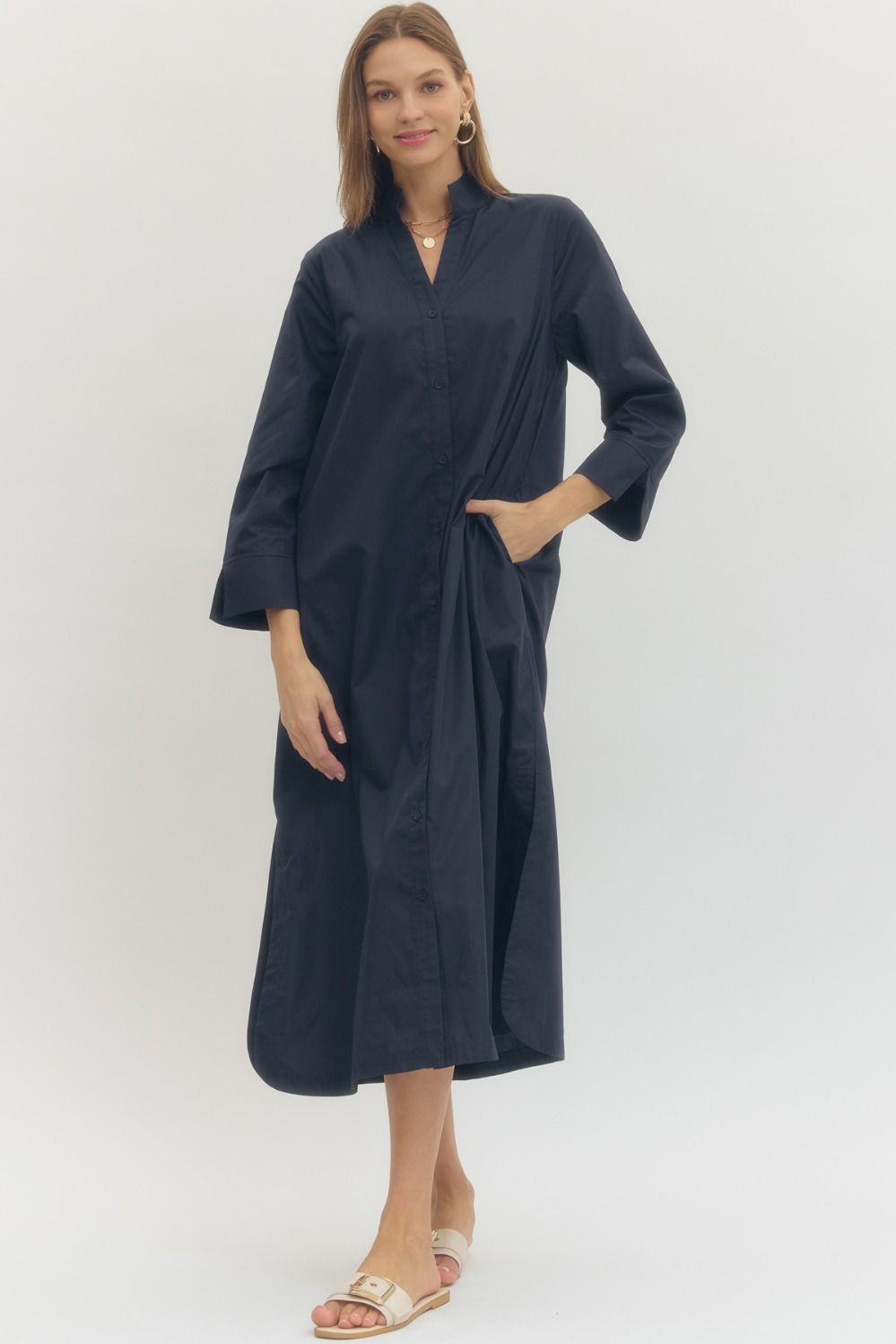 Woman wearing a navy blue dress against a white background