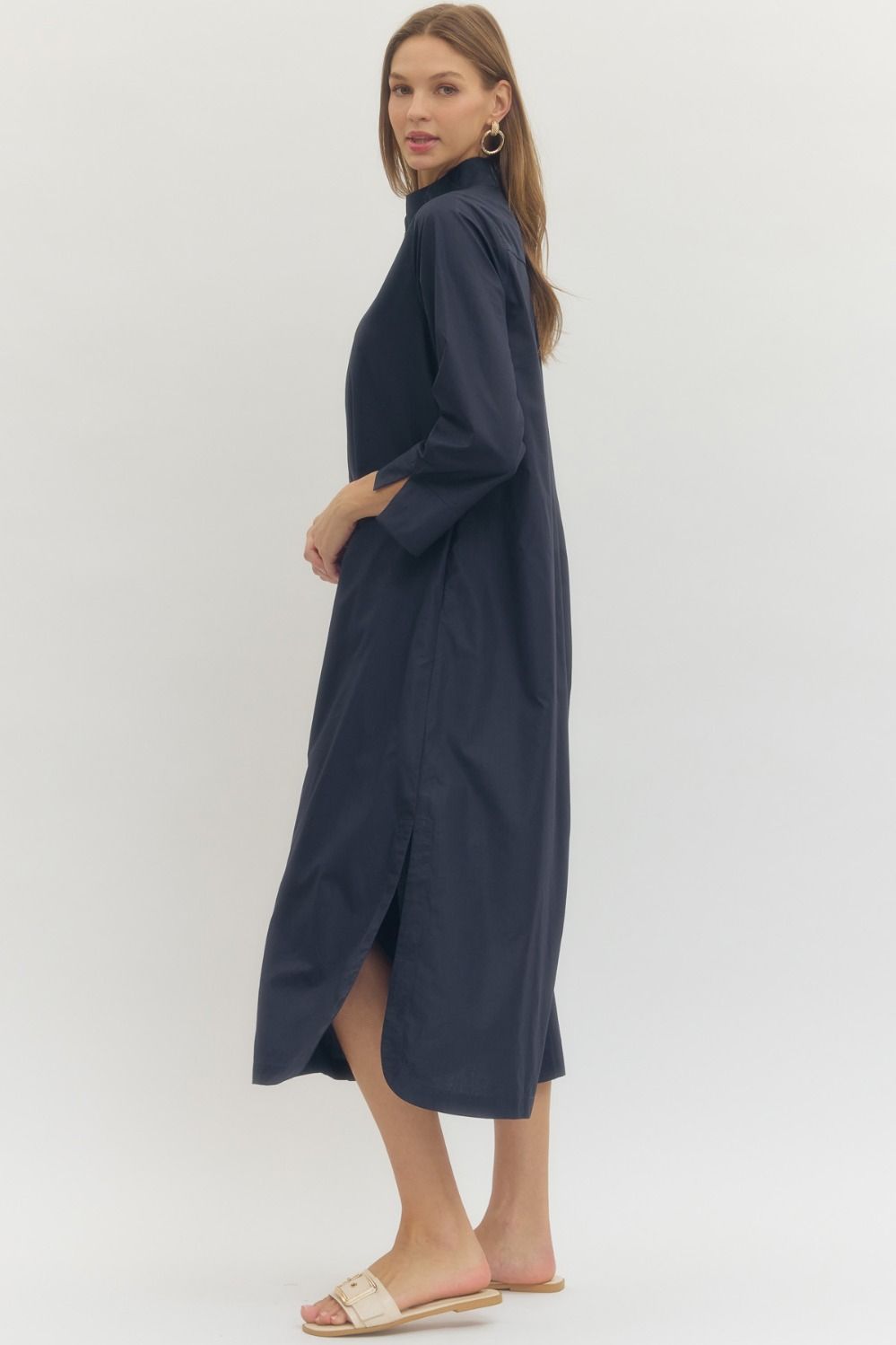 Woman wearing a navy blue dress on a white background