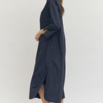 Woman wearing a navy blue dress on a white background