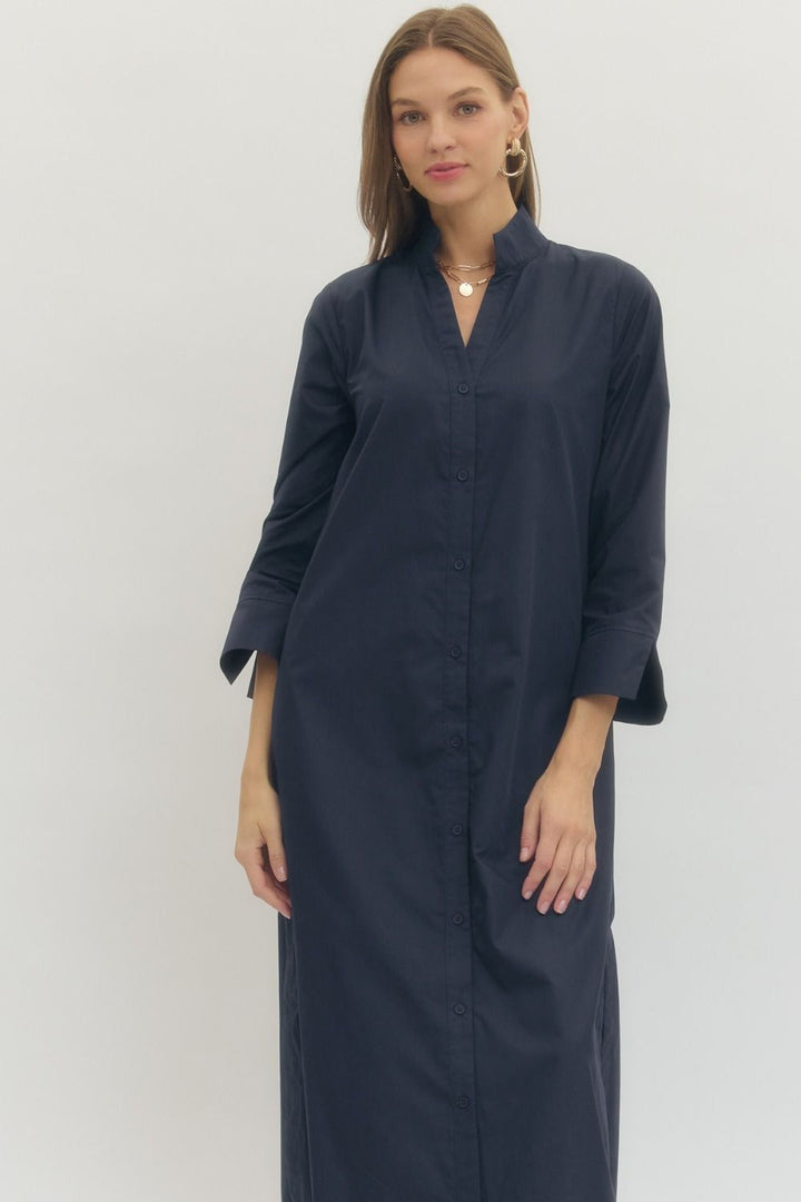 Woman wearing a navy blue dress against a white background