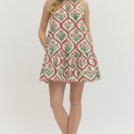 Woman wearing a patterned dress on a white background